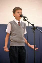 4th grader reciting a poem by Walt Whitman